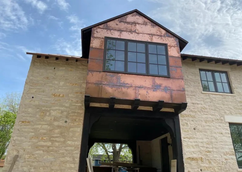 Copper metal panel facade on a stone building for Roof Repair in Monterey