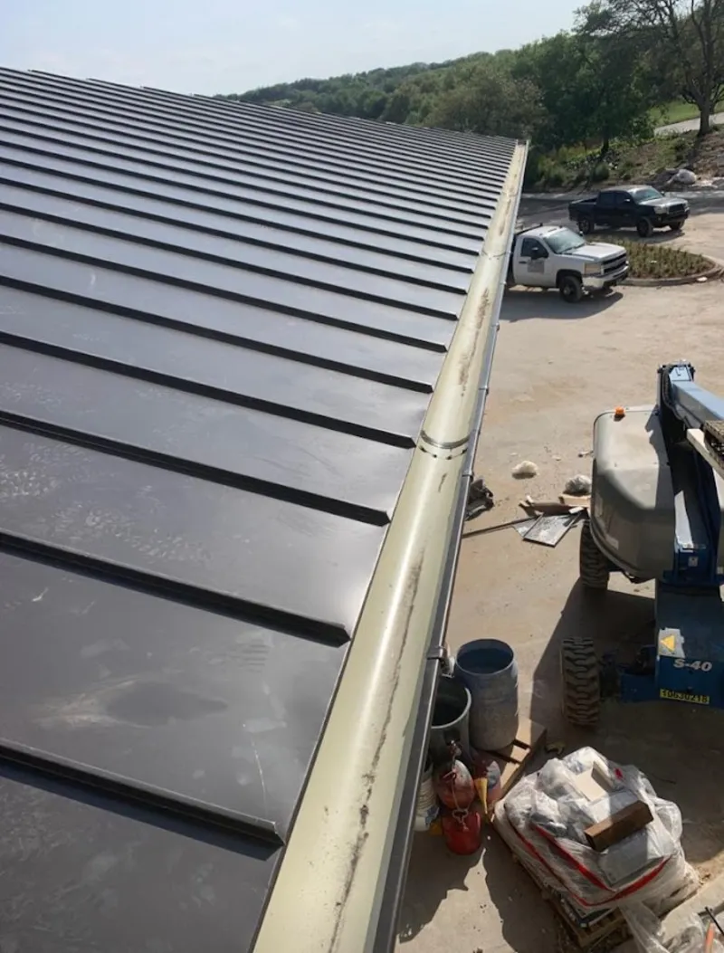 Standing seam panel and gutter detail on a metal roofing jobsite in Monterey